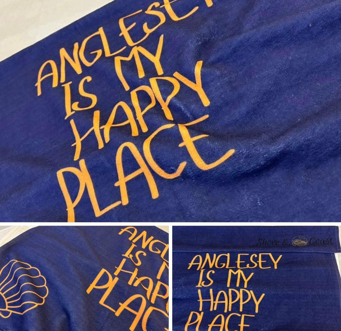alt=“Navy microfibre beach towel with cotton loops featuring the slogan ‘Anglesey is my happy place’ in bold orange text – quick-drying, absorbent, and perfect for the coast”