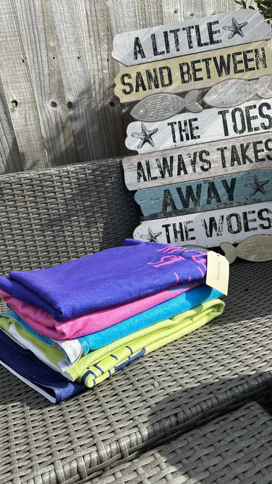 alt=“Set of 4 Anglesey-themed microfibre beach towels from Shore & Coast – quick-drying, lightweight, and perfect for seaside days”