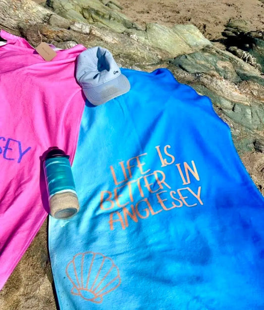 alt=“Set of 2 Anglesey-themed microfibre beach towels from Shore & Coast – lightweight, quick-drying, and perfect for beach days”